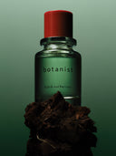 Björk and Berries botanist eau de perfume and standing on a pice of moss, with a green background. 