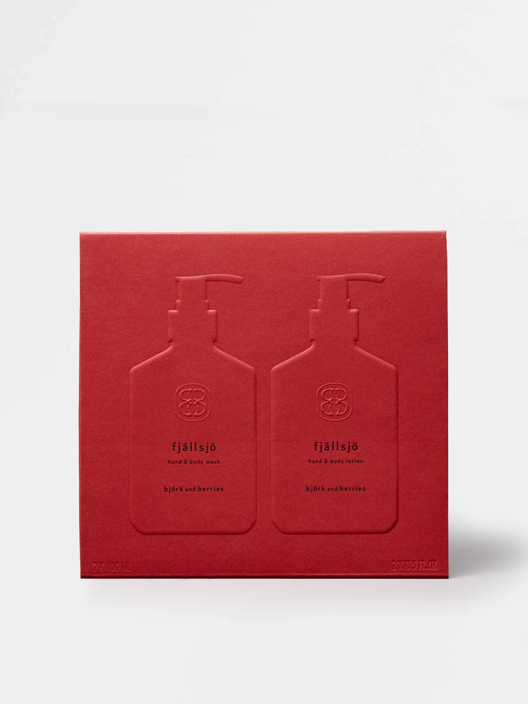 Red gift box with two embossed bottles on a white background