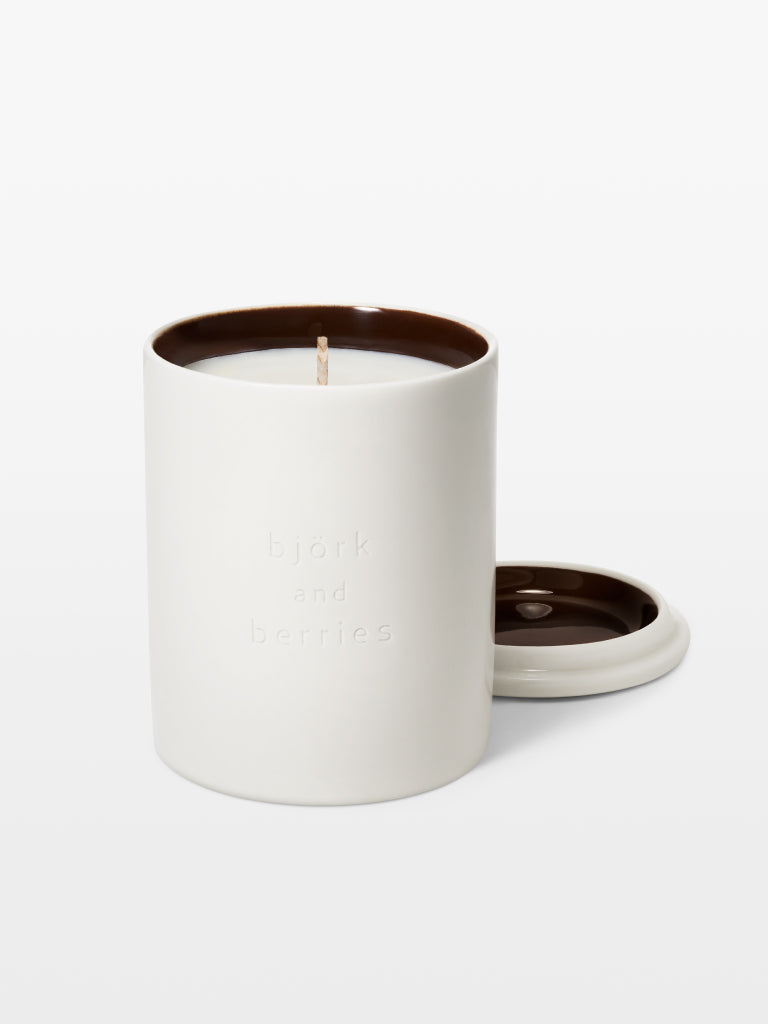 Björk and Berries scented candle white forest with the lid off and placed with a white background. 