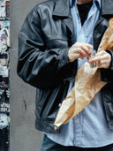 Showing a faceless man holding a Björk and berries travel perfume, in an everyday situation, showing the flexability of the treavel bottle. 